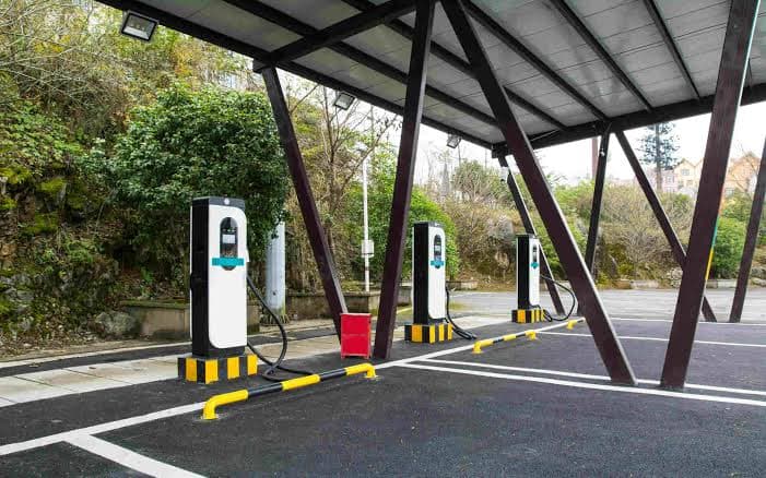 Commercial EV charging bay with multiple terminals under a covered carport